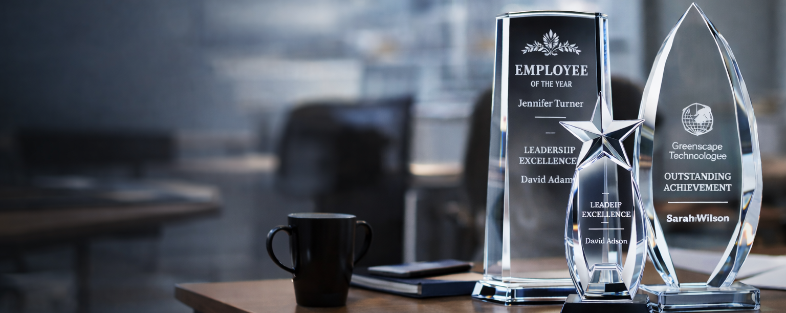 Acrylic awards on a desk with a blurred office background